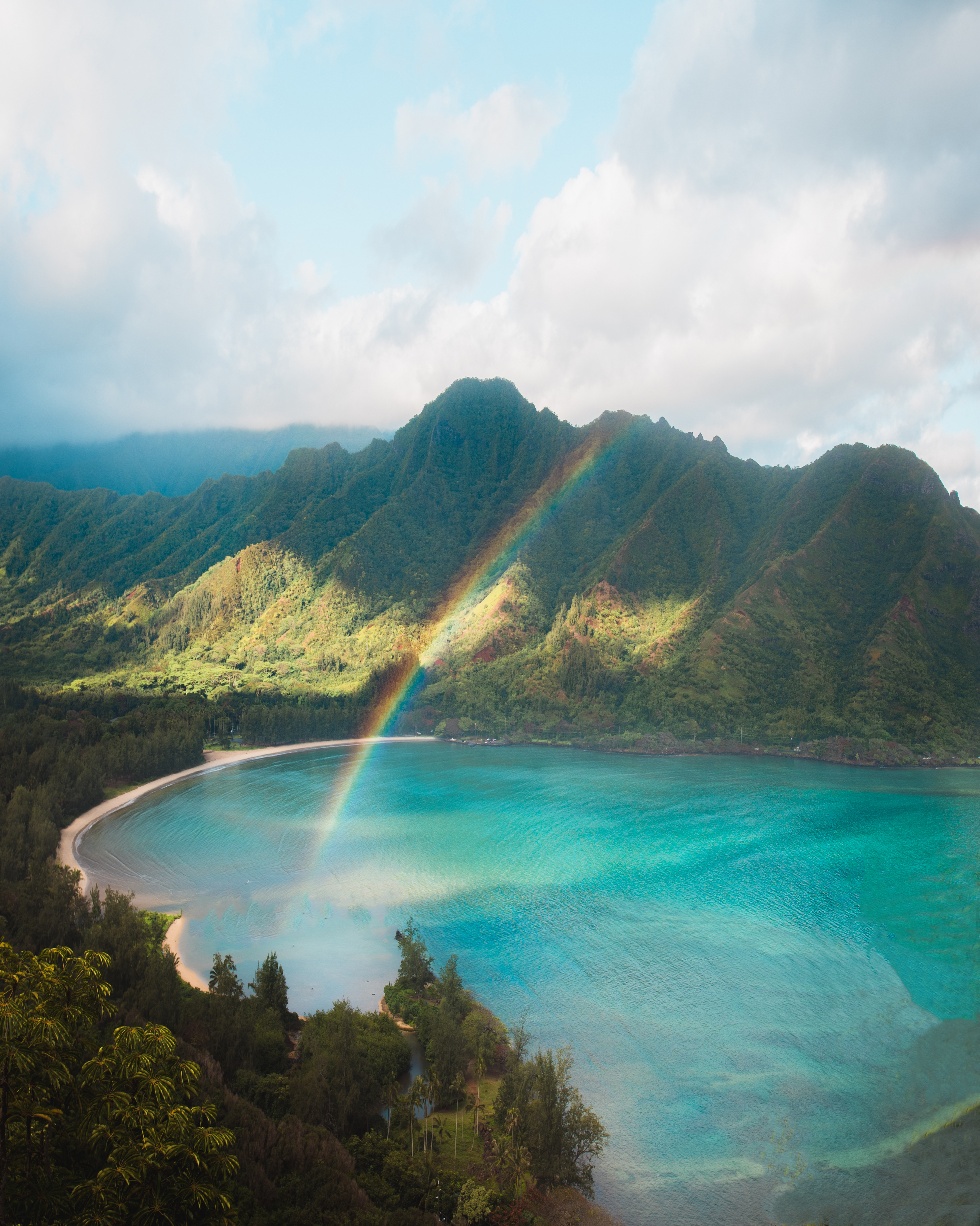 rainbow over white sand beach