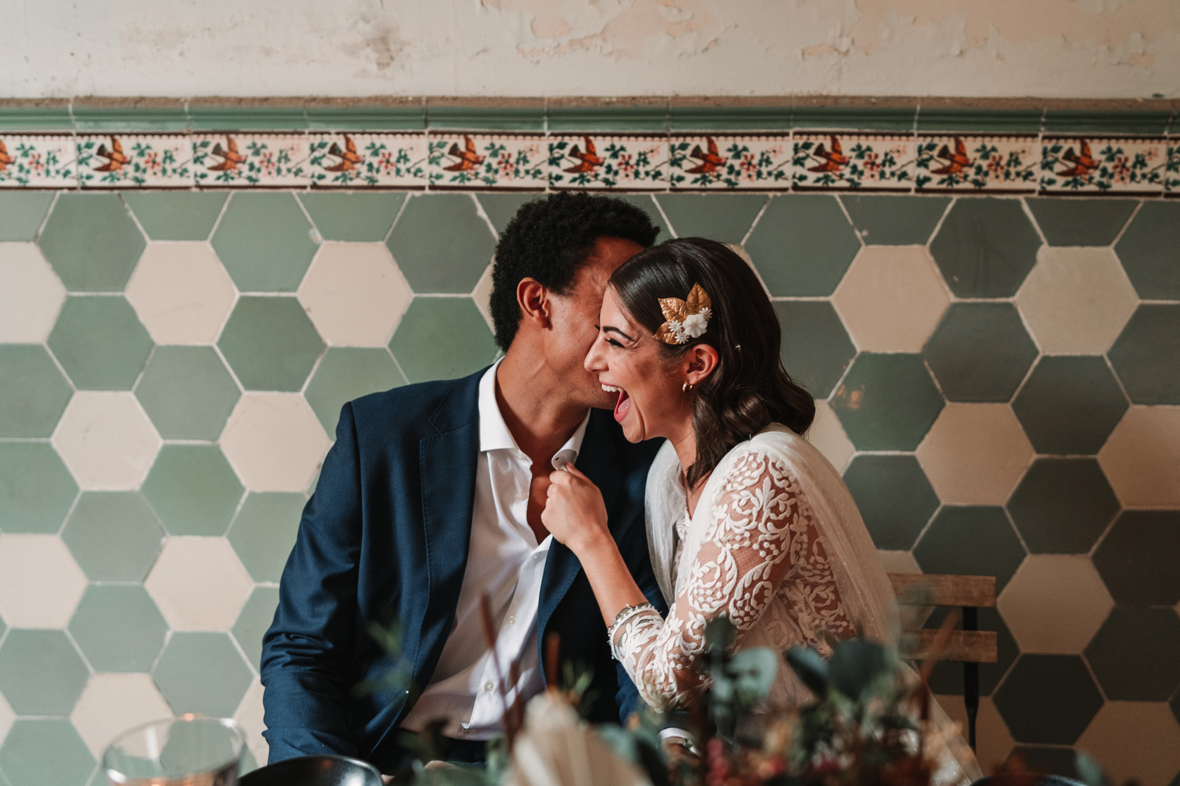 wedding couple in front of tile background