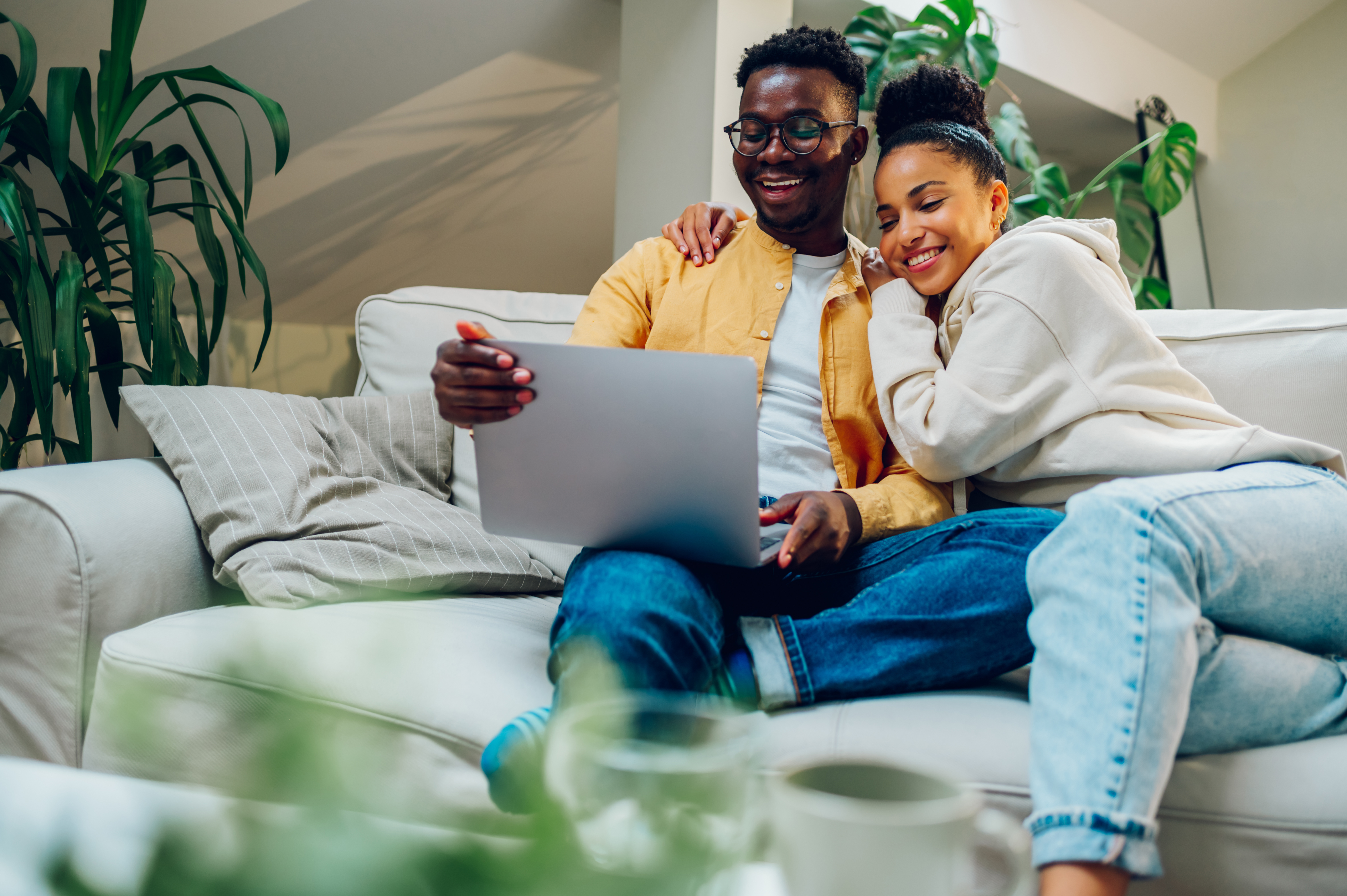 Couple reviewing travel credit card options on a laptop