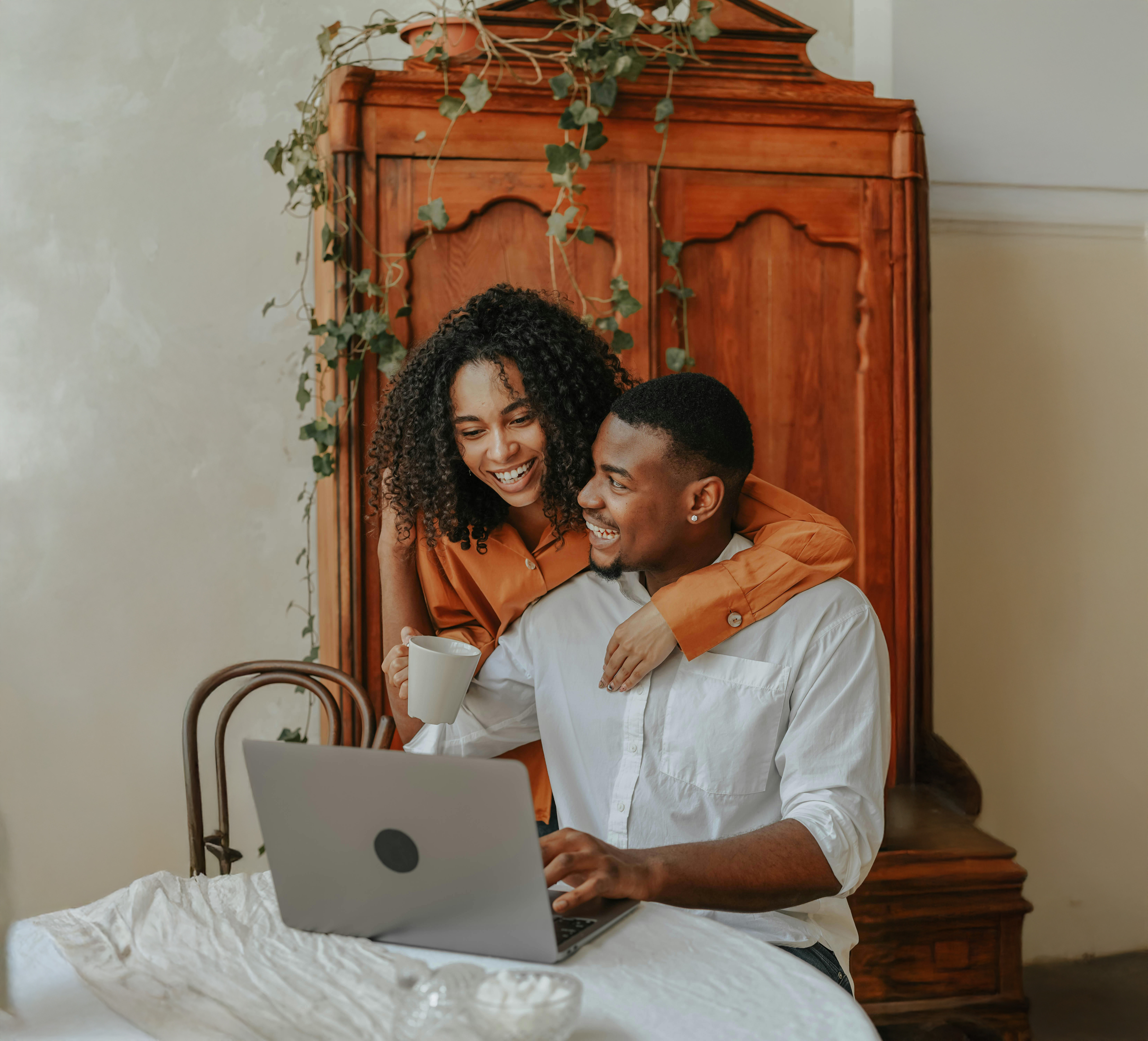 Couple comparing featured credit cards on a laptop